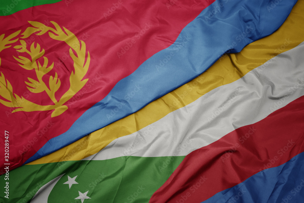 waving colorful flag of comoros and national flag of eritrea.
