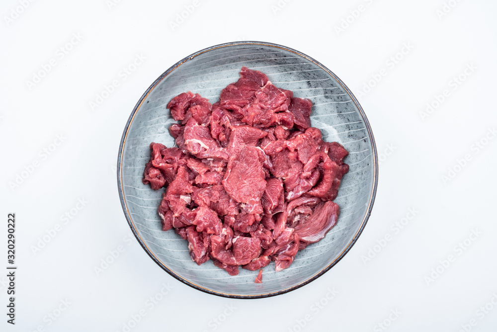 Fresh beef slices on a plate on white background Fresh beef slices on a plate on white background