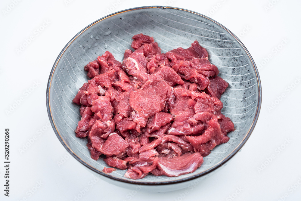 Fresh beef slices on a plate on white background Fresh beef slices on a plate on white background