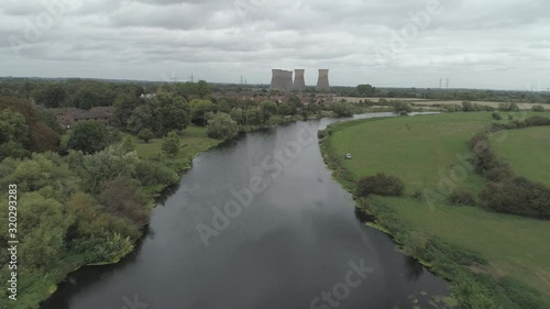 Aerial pull back shot over the River Trent with Willington Power Station cooling towers in the distance photo