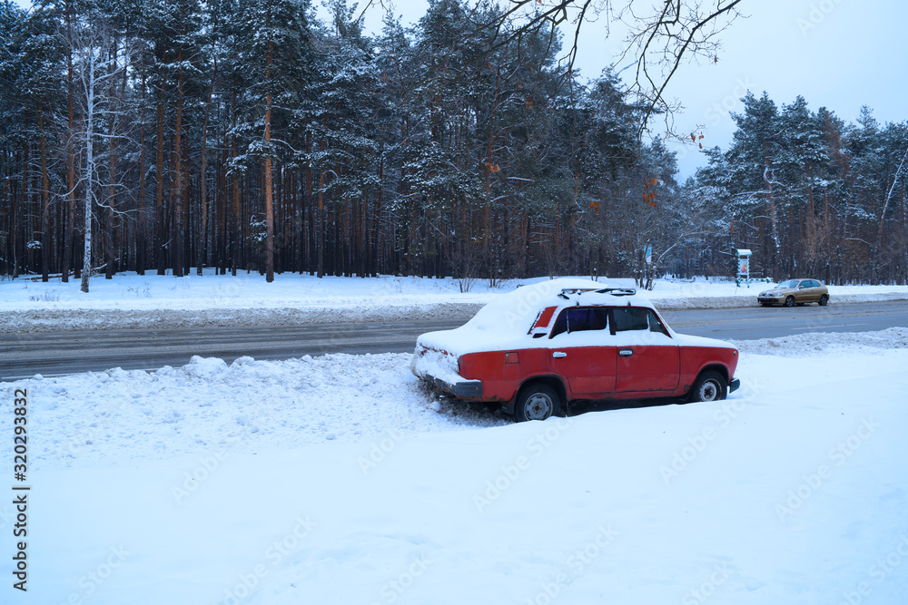 View of the car near the road in winter in nature.