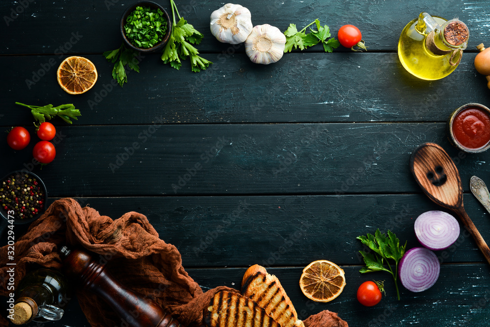 Black food background. Vegetables and spices on black background. Top view. Free space for your text. Black food background. Vegetables and spices on black background. Top view. Free space for your text.