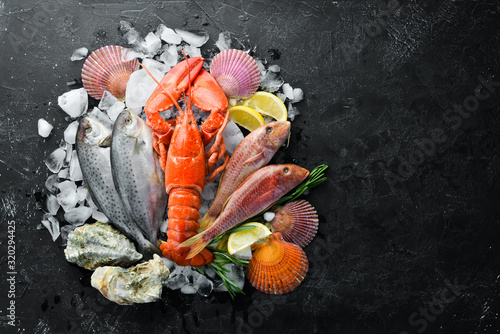 Seafood on stone background. Lobster, fish, shellfish. Top view. Free copy space.