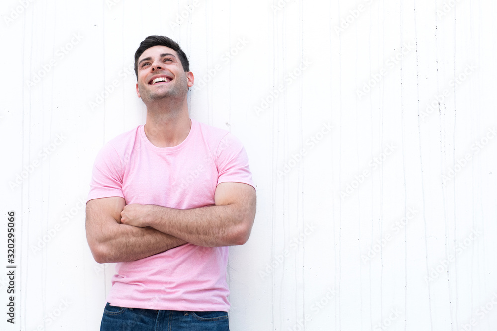 handsome young man with happy face expression and arms crossed by white background handsome young man with happy face expression and arms crossed by white background