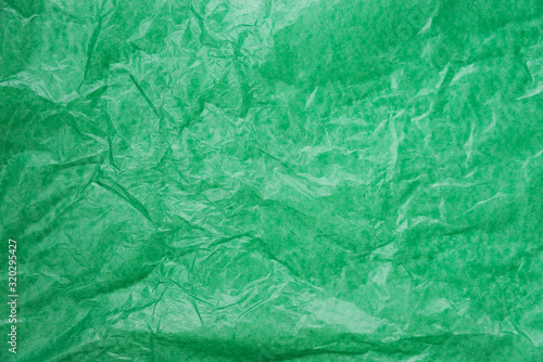 abstract background green crumpled transparent paper on white paper.