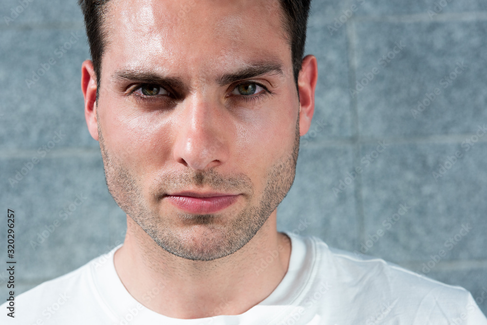Fototapeta premium Close up face serious handsome young man
