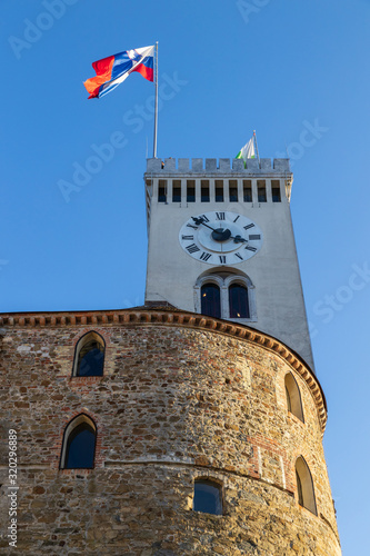 Clocktower with Slovenian flag in Ljubljana castle