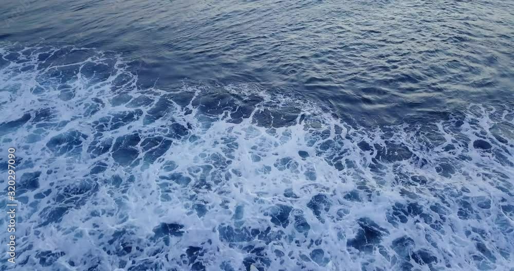 Aerial tilt up directly above surfers on sea at sunset, Bali indonesia Aerial tilt up directly above surfers on sea at sunset, Bali indonesia