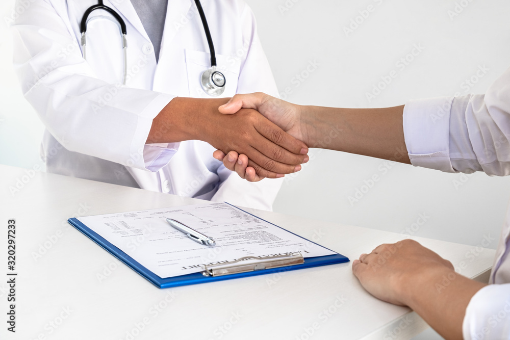 Doctors and patients shake hands after the patient has finished treatment. Medical concepts and good health Doctors and patients shake hands after the patient has finished treatment. Medical concepts and good health