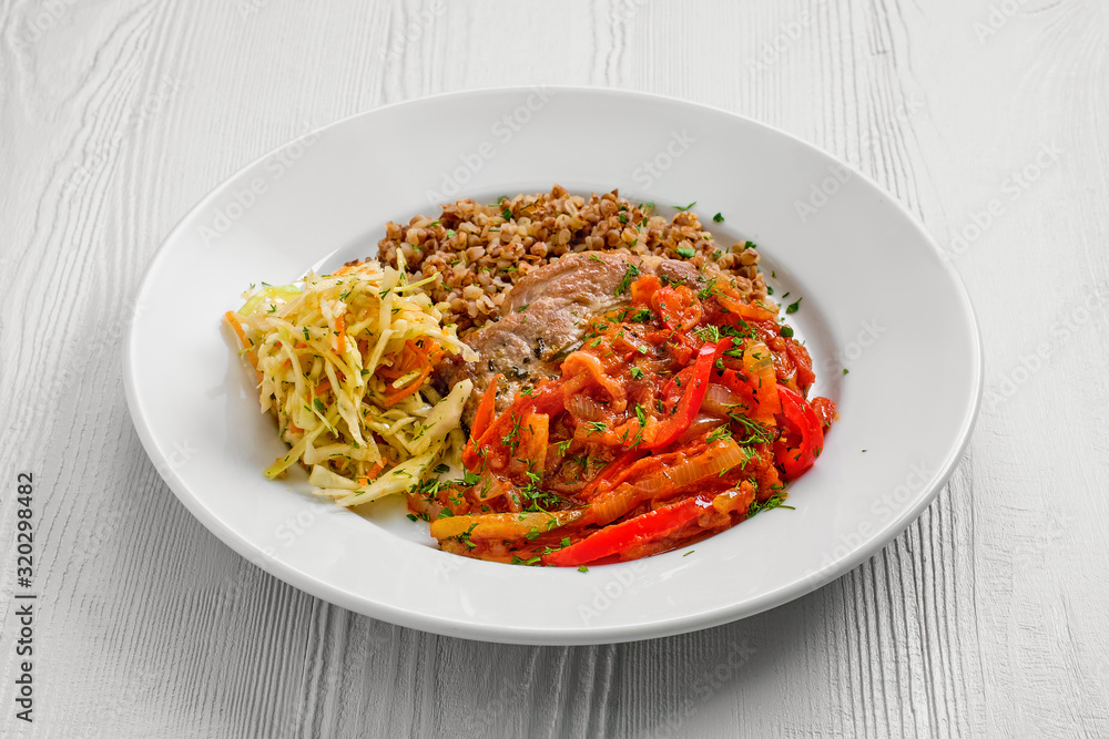 Plate with chopped meat backed with bell pepper with buckwheat and cabbage salad Plate with chopped meat backed with bell pepper with buckwheat and cabbage salad