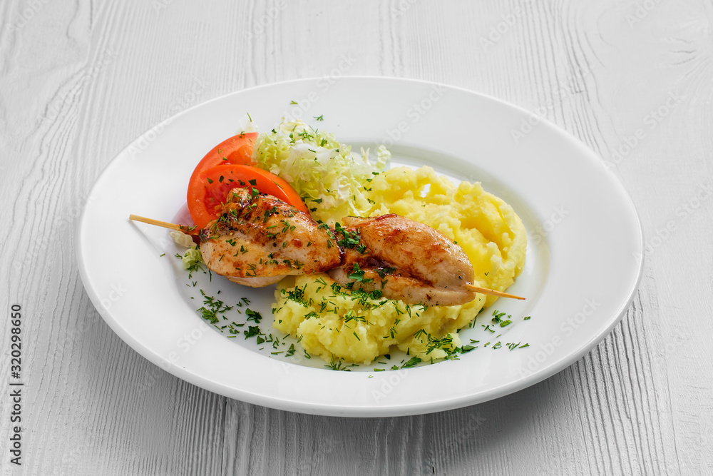 Plate with chicken shashlik, mashed potato and cabbage salad