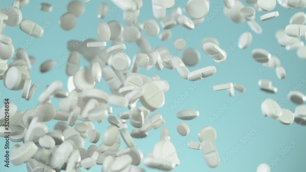 Super slow motion of falling white pills on blue background. Filmed on high speed cinema slow motion camera, 1000fps. Super slow motion of falling white pills on blue background. Filmed on high speed cinema slow motion camera, 1000fps.
