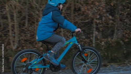 Little boy is cycling in the neighborhood - 4k - 24fps - slow motion - Part13 photo