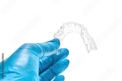 Wallpaper Mural Hand holding individual dental tray for bleaching teeth Isolated on a white background Torontodigital.ca