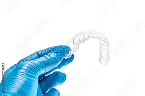 Hand holding individual dental tray for bleaching teeth Isolated on a white background