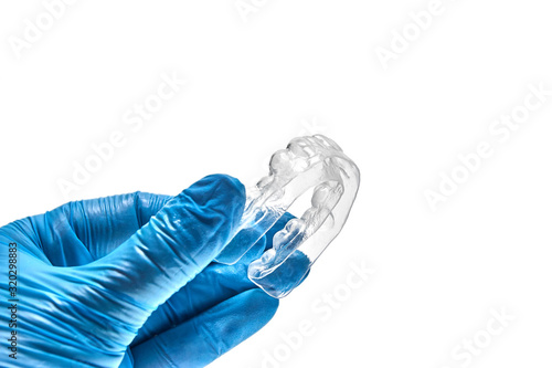 Wallpaper Mural Hand holding individual dental tray for bleaching teeth Isolated on a white background Torontodigital.ca