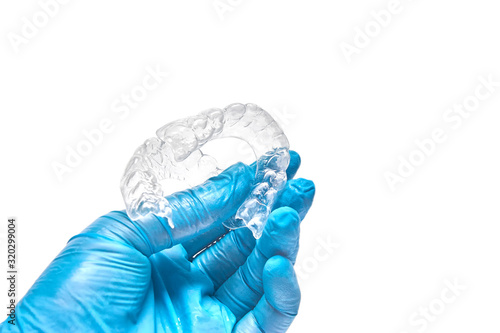 Wallpaper Mural Hand is holding set of custom dental trays for bleaching teeth. Isolated on a white background Torontodigital.ca