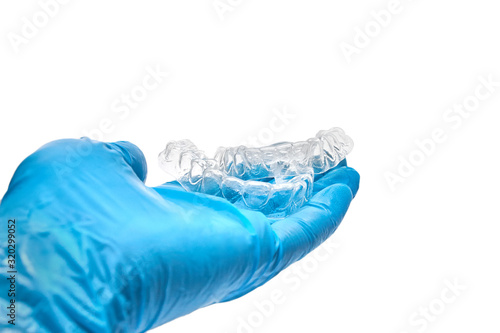 Wallpaper Mural Hand is holding set of custom dental trays for bleaching teeth. Isolated on a white background Torontodigital.ca