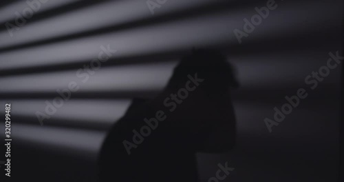silhouette of a disturbed individual pacing back and forth.