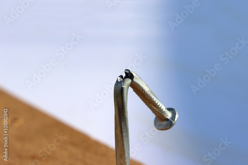 Tableau sur toile Broken and defective new metal nail closeup