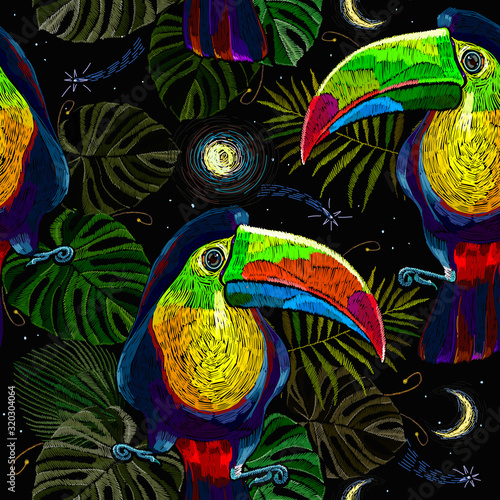 Colorful keel-billed toucan birds, moon and palm leaves seamless pattern. Embroidery art. Ramphastos sulfuratus. Jungle paradise background. Fashionable template for design of clothes, textiles