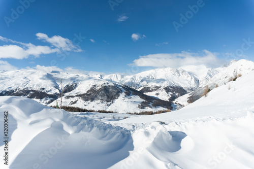 Snowy mountains with great cloudy blue sky © Jan