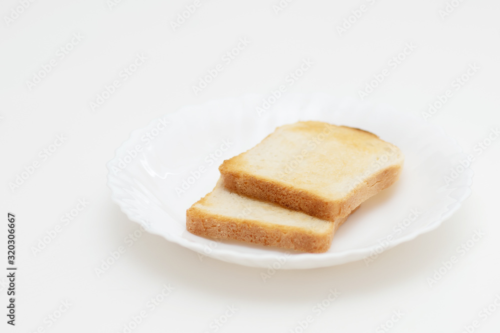 Toasted toasts on a white plate. Breakfast is delicious and healthy. Toasted toasts on a white plate. Breakfast is delicious and healthy.