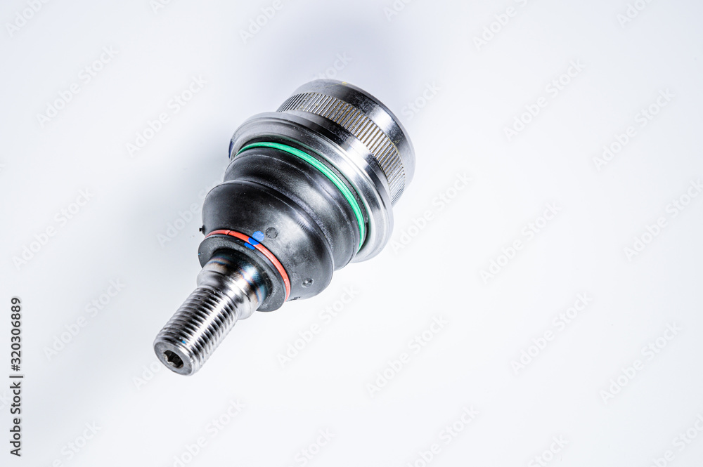 New spare parts spherical ball joints of a suspension bracket of a car on a gray background New spare parts spherical ball joints of a suspension bracket of a car on a gray background