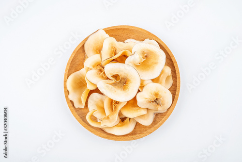 Dried seafood snails on a plate on white background