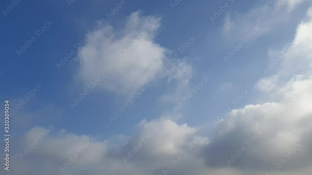 Awesome time lapse of blue summer sky with dense thick thunderstorm rain clouds moving across the heavens. Fast cloud formation and movement creating a surreal cloudscape time lapse. Awesome time lapse of blue summer sky with dense thick thunderstorm rain clouds moving across the heavens. Fast cloud formation and movement creating a surreal cloudscape time lapse.