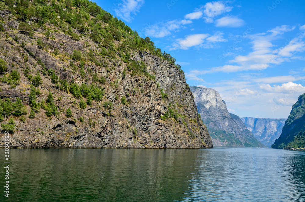 Naeroyfjord, a tributary of the giant Sognefjord. The narrow fjord is know for steep mountainsides, waterfalls, snow fields, picturesque farms and hamlets. It is a major attraction of western Norway 