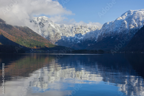 The clear water of Hallstattersee lake and the beautiful mountains surrounding it in Salzkammergut region, Austria, in winter