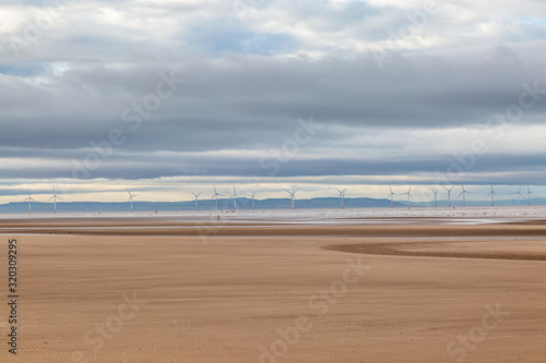 Low tide at Formby beach with an off shore wind farm and the Welsh hills in the distance