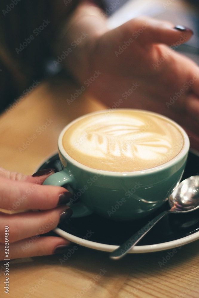 Close up of female hands holding coffee mug
