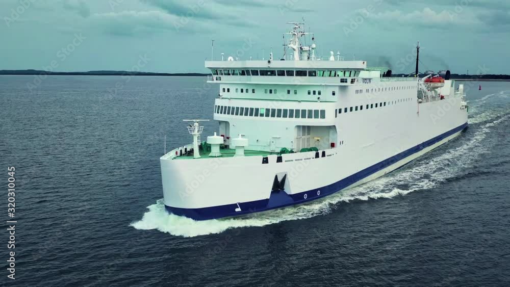 Ferry boat sailing in the calm sea tin direction to the camera. Ferry boat sailing in the calm sea tin direction to the camera.
