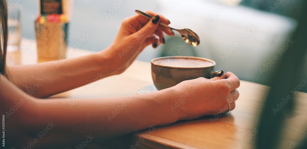 Close up of female hands holding coffee mug