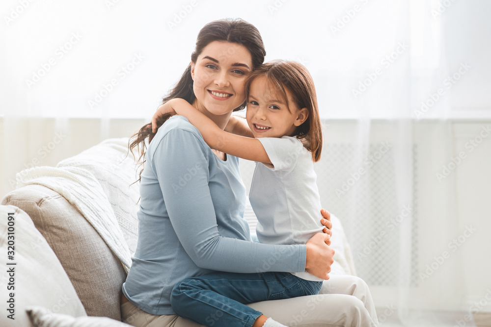 Portrait of pregnant woman and her little daughter hugging Portrait of pregnant woman and her little daughter hugging