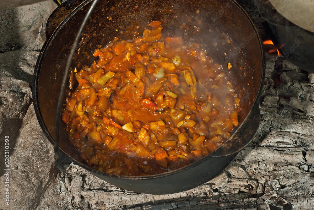Food on a hike. Dinner is cooked on a fire. Food in a big black boiler. Food on a hike. Dinner is cooked on a fire. Food in a big black boiler.