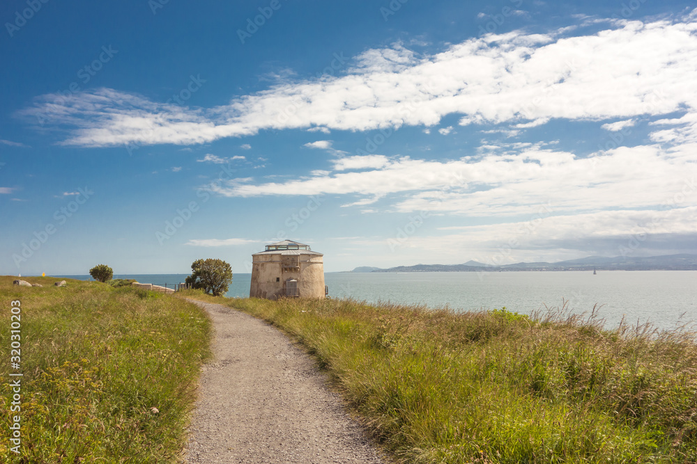 View of a Martello Tower and Dublin Bay at Red Rock, Sutton on Howth Head Peninsula near Dublin, Ireland. View of a Martello Tower and Dublin Bay at Red Rock, Sutton on Howth Head Peninsula near Dublin, Ireland.