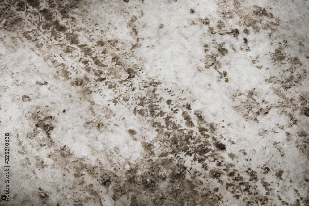 Obraz premium Texture of snow on the road tracks and dirt