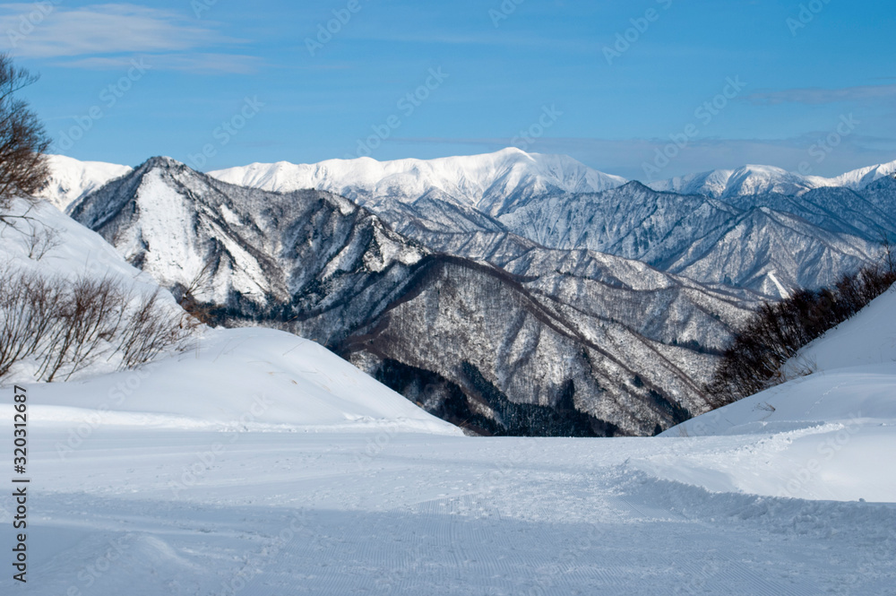 Fototapeta premium beautiful scenery from top view, mountains under the snow during winter time