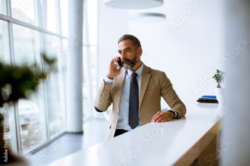 Senior businessman using mo...