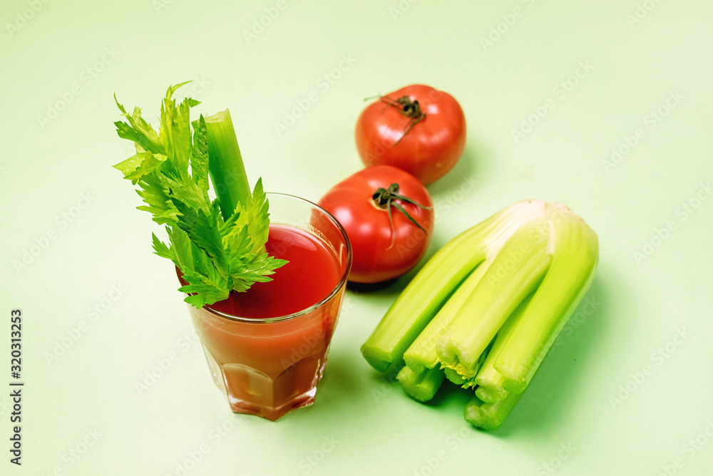 Glass of Tasty and Healthy Tomatoes and Celery Juice Raw Tomatoes and Celery on Green Background Horizontal Glass of Tasty and Healthy Tomatoes and Celery Juice Raw Tomatoes and Celery on Green Background Horizontal