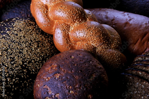 Fresh collection of bread and wheat on the table. Collection of different types of bread: White, rye, seed, form bread. lots of photos of bread with rye ears