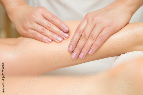 Woman getting leg massage in spa center