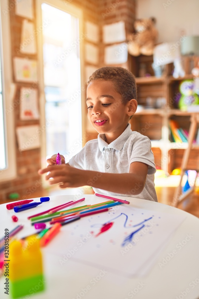 Beautiful african american toddler drawing using paper and marker pen at kindergarten - obrazy, fototapety, plakaty 