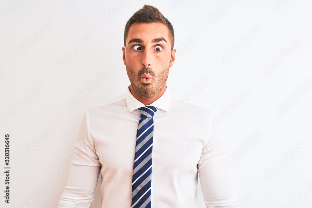 Young handsome elegant business man over isolated background making fish face with lips, crazy and comical gesture. Funny expression. Young handsome elegant business man over isolated background making fish face with lips, crazy and comical gesture. Funny expression.
