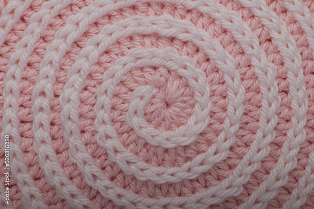 Fototapeta premium Сolorful balls of wool yarn and knitting wooden needles in a wicker basket on a white background. Still life, place for text, closeup