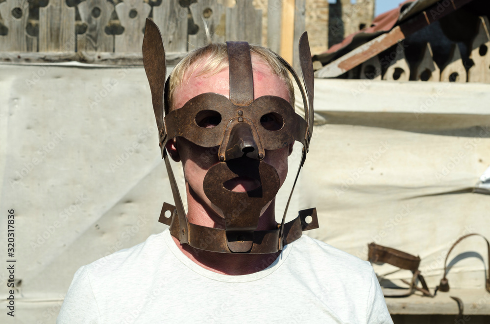medieval torture mask on blond man Stock Photo | Adobe Stock