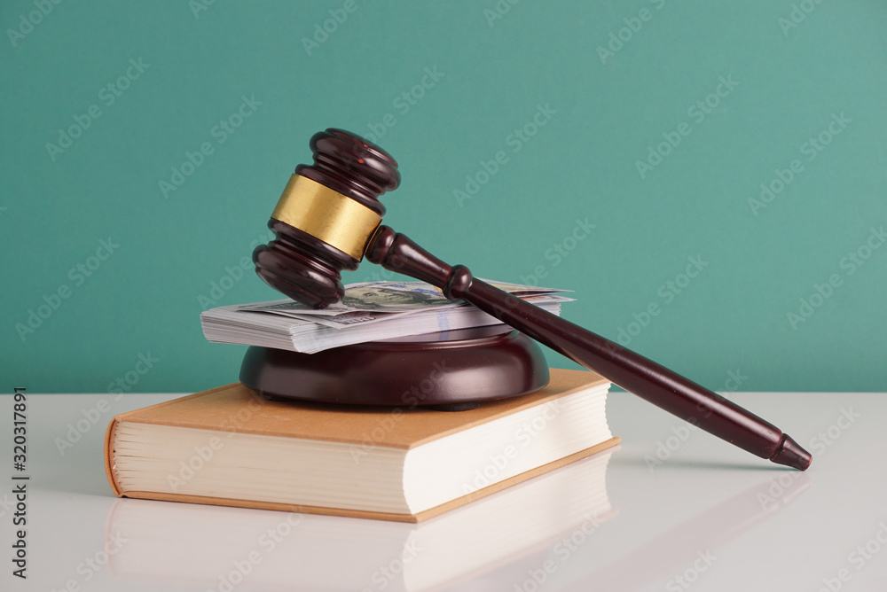 wooden gavel, money and law books wooden gavel, money and law books